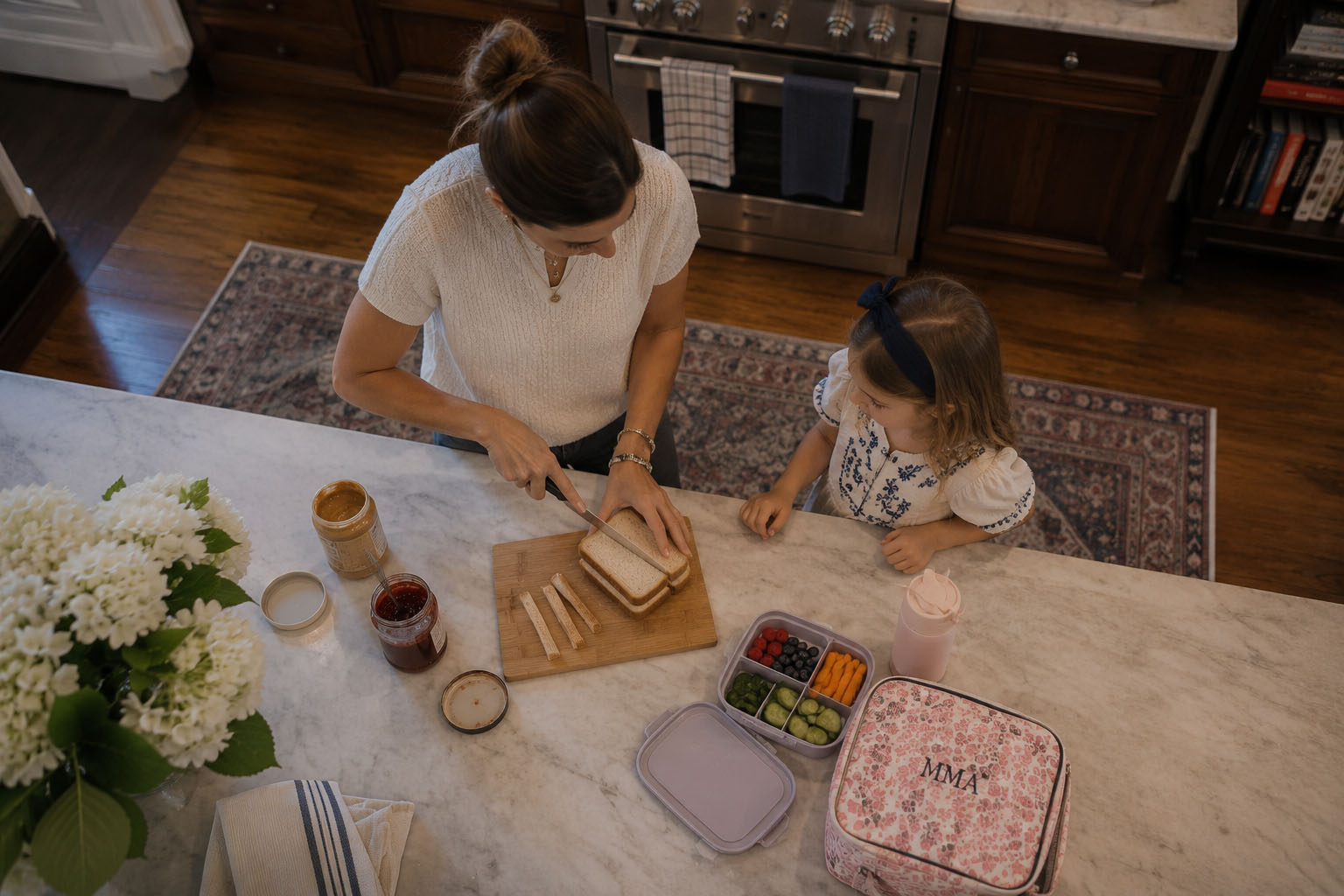 Professional New York City nanny preparing a healthy lunch with a young child at home